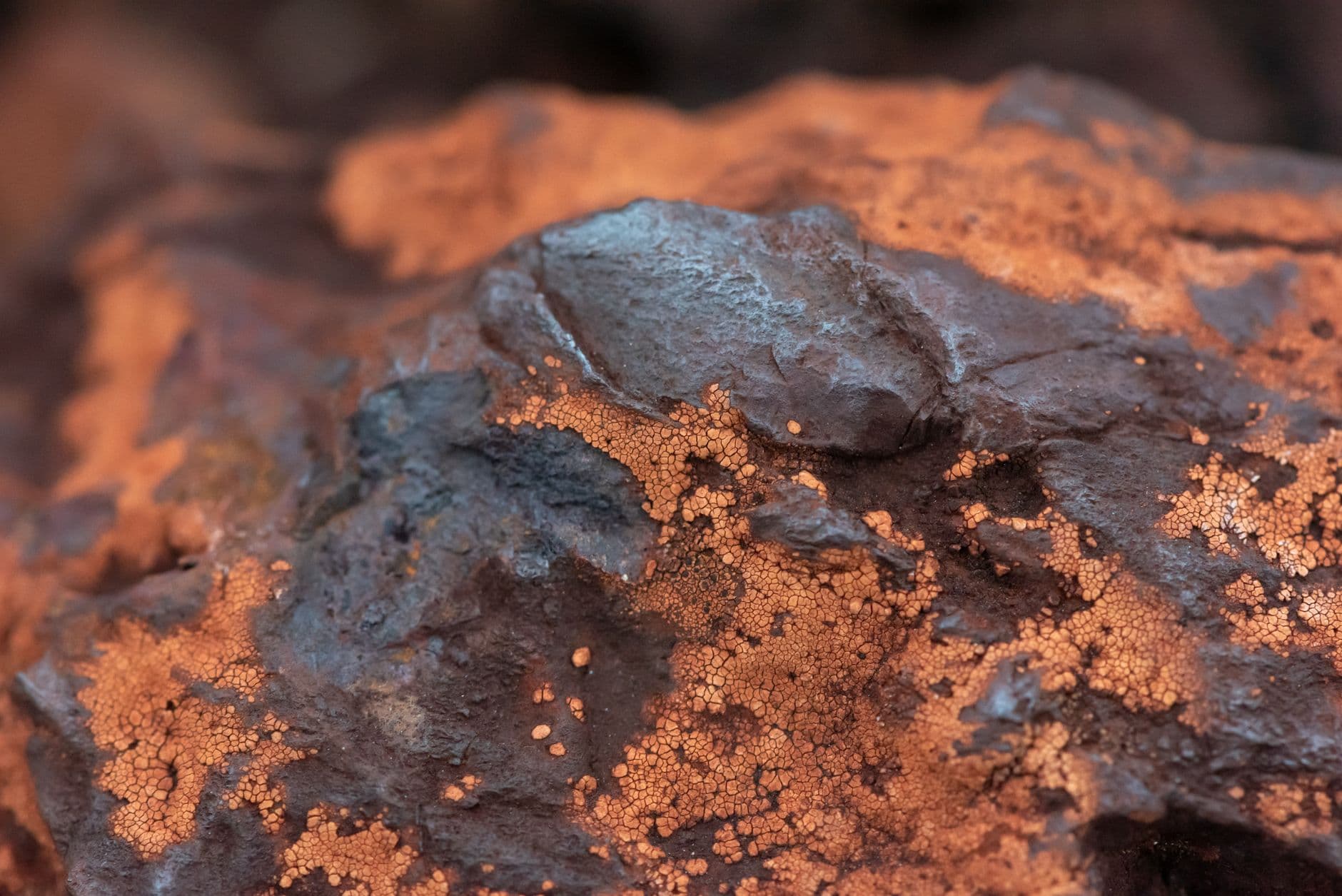 Raw iron ore rock showing its banded mineral texture.